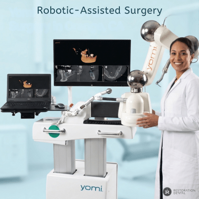 A dental provider standing next to the Yomi robotic-assisted dental surgery system with digital scans on monitors, ensuring gentle treatment for anxious patients.